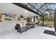 Enclosed patio features furniture, decor and views of the large backyard at 43411 State Road 19, Altoona, FL 32702