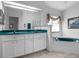 Bathroom with double sink vanity, garden tub, and a neutral color palette perfect for relaxation at 4547 Inverness Dr, Leesburg, FL 34748