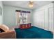 Cozy bedroom with blue carpet, window, closet, and ceiling fan at 4547 Inverness Dr, Leesburg, FL 34748