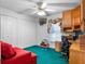 Bedroom with built-in desk, ceiling fan, and double door closet providing ample storage space at 4547 Inverness Dr, Leesburg, FL 34748