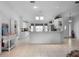 Open-concept kitchen boasts granite counters, white cabinets, and a breakfast bar overlooking the living area at 4547 Inverness Dr, Leesburg, FL 34748