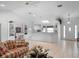 Open-concept kitchen with granite countertops, white cabinetry, and a seamless flow into the living area at 4547 Inverness Dr, Leesburg, FL 34748