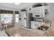 Bright kitchen featuring stainless steel appliances, granite countertops, and a cozy breakfast nook by the windows at 4547 Inverness Dr, Leesburg, FL 34748