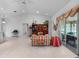 Bright living room featuring vaulted ceilings, tile flooring, and sliding glass doors leading to outdoor space at 4547 Inverness Dr, Leesburg, FL 34748