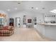 Open-concept living space with tiled floors, vaulted ceilings, and a breakfast bar connecting to the kitchen at 4547 Inverness Dr, Leesburg, FL 34748