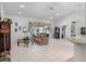 Spacious living room with vaulted ceilings, tile floors, and large sliding glass doors to the lanai at 4547 Inverness Dr, Leesburg, FL 34748