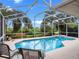 Inviting screened-in pool with sun chairs and lush landscaping provides a private outdoor retreat at 4547 Inverness Dr, Leesburg, FL 34748