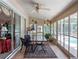Enclosed sunroom with tile flooring and sliding glass doors overlooking the pool area at 4547 Inverness Dr, Leesburg, FL 34748