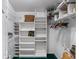 Spacious walk-in closet with white shelving and wire baskets provides ample storage space at 4547 Inverness Dr, Leesburg, FL 34748
