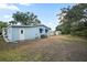 View of house and backyard showing the yard, house and A/C unit at 522 Saint Andrews Blvd, Lady Lake, FL 32159