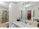 Bright bathroom with floral shower curtain, vanity, sink, and ample storage at 522 Saint Andrews Blvd, Lady Lake, FL 32159