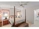 Bedroom with a four-poster bed, ceiling fan, and natural light from the windows at 522 Saint Andrews Blvd, Lady Lake, FL 32159