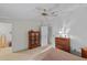 Bedroom featuring wooden furniture, ceiling fan, and access to the bathroom at 522 Saint Andrews Blvd, Lady Lake, FL 32159