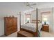 Traditional bedroom features a four-poster bed, wooden furniture, and a ceiling fan at 522 Saint Andrews Blvd, Lady Lake, FL 32159