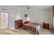 Bedroom with ceiling fan, bedside tables, and walk-in bathroom at 522 Saint Andrews Blvd, Lady Lake, FL 32159