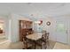 Dining room with hutch, table, and chairs next to doorway to entry at 522 Saint Andrews Blvd, Lady Lake, FL 32159