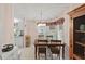 Charming dining area with wooden furniture set and natural light from the windows at 522 Saint Andrews Blvd, Lady Lake, FL 32159