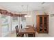 Elegant dining room featuring a chandelier, wooden table set, and natural light from the windows at 522 Saint Andrews Blvd, Lady Lake, FL 32159