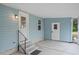 Covered entrance featuring a well-lit doorway, stairs, and neutral siding at 522 Saint Andrews Blvd, Lady Lake, FL 32159