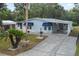 Charming single-story home with blue siding, awnings, and a well-maintained front yard at 522 Saint Andrews Blvd, Lady Lake, FL 32159