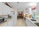 Bright kitchen featuring white cabinets, countertops, and appliances, offering a clean and functional space at 522 Saint Andrews Blvd, Lady Lake, FL 32159