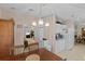 Eat-in kitchen with white cabinets and appliances, adjacent dining and living areas at 522 Saint Andrews Blvd, Lady Lake, FL 32159