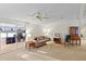 Comfortable living room with a ceiling fan and sliding glass doors to another room at 522 Saint Andrews Blvd, Lady Lake, FL 32159