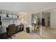 Well-lit office featuring a comfortable chair, spacious desk, and sliding door access to the living room at 522 Saint Andrews Blvd, Lady Lake, FL 32159