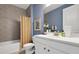 Stylish bathroom featuring a shower with hexagon tiles, a white vanity, and modern fixtures at 5463 Nickerbean St, Apopka, FL 32712