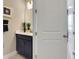 This bathroom features a navy vanity, gold fixtures, neutral walls, and tile flooring at 5463 Nickerbean St, Apopka, FL 32712