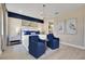 Stylish bedroom featuring a blue accent wall, modern furniture, and decor for a comfortable setting at 5463 Nickerbean St, Apopka, FL 32712
