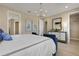 Elegant bedroom with neutral color scheme, modern chandelier, and decor, creating a soothing retreat at 5463 Nickerbean St, Apopka, FL 32712