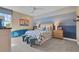 Bright bedroom with a cozy bed, beach-themed decor, and soft natural light at 5463 Nickerbean St, Apopka, FL 32712