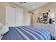 Cozy bedroom with a striped blue bedspread, white dresser, and plenty of storage space at 5463 Nickerbean St, Apopka, FL 32712