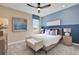 Comfortable bedroom featuring neutral tones, a blue accent wall, and abundant natural light at 5463 Nickerbean St, Apopka, FL 32712