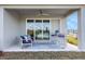 Relaxing covered patio with ceiling fan and stylish outdoor furniture at 5463 Nickerbean St, Apopka, FL 32712
