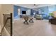 Spacious living room with a foosball table, seating area, and modern decorations at 5463 Nickerbean St, Apopka, FL 32712