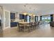 Spacious kitchen with an island, modern pendant lighting, stainless steel appliances, and open to the living area at 5463 Nickerbean St, Apopka, FL 32712