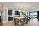 Modern kitchen features navy cabinets, large island with seating, stainless appliances, and pendant lighting at 5463 Nickerbean St, Apopka, FL 32712