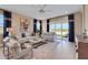 Spacious living room featuring contemporary decor, hardwood floors, and natural light at 5463 Nickerbean St, Apopka, FL 32712
