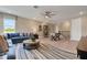 Open living room with a comfortable sofa, stylish rug, and natural light from the large windows at 5463 Nickerbean St, Apopka, FL 32712