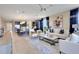 Open-concept living area blends living, dining, and kitchen spaces with modern furnishings and decor at 5463 Nickerbean St, Apopka, FL 32712
