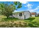 Well maintained home featuring a grassy backyard and mature trees, offering a serene outdoor setting at 741 Royal Palm Ave, Lady Lake, FL 32159