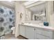 Bright bathroom featuring a shower, toilet, and vanity with storage at 741 Royal Palm Ave, Lady Lake, FL 32159
