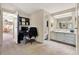Open area with office space and a connected full bathroom with storage cabinets at 741 Royal Palm Ave, Lady Lake, FL 32159
