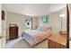 Bedroom featuring neutral walls, carpet floors, dresser, and an inviting bed with soft lighting at 741 Royal Palm Ave, Lady Lake, FL 32159
