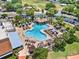 Aerial view of the outdoor community pool with palm trees, loungers, and shaded seating areas at 741 Royal Palm Ave, Lady Lake, FL 32159