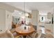 Dining area with a wooden table, chandelier lighting, ceiling fan, and views to the living room and kitchen at 741 Royal Palm Ave, Lady Lake, FL 32159