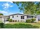 Charming home featuring a carport, landscaped lawn, and a cozy front porch with a decorative wreath at 741 Royal Palm Ave, Lady Lake, FL 32159