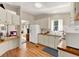 Bright kitchen featuring white cabinets, wooden countertops, and hardwood floors with a view to living area at 741 Royal Palm Ave, Lady Lake, FL 32159